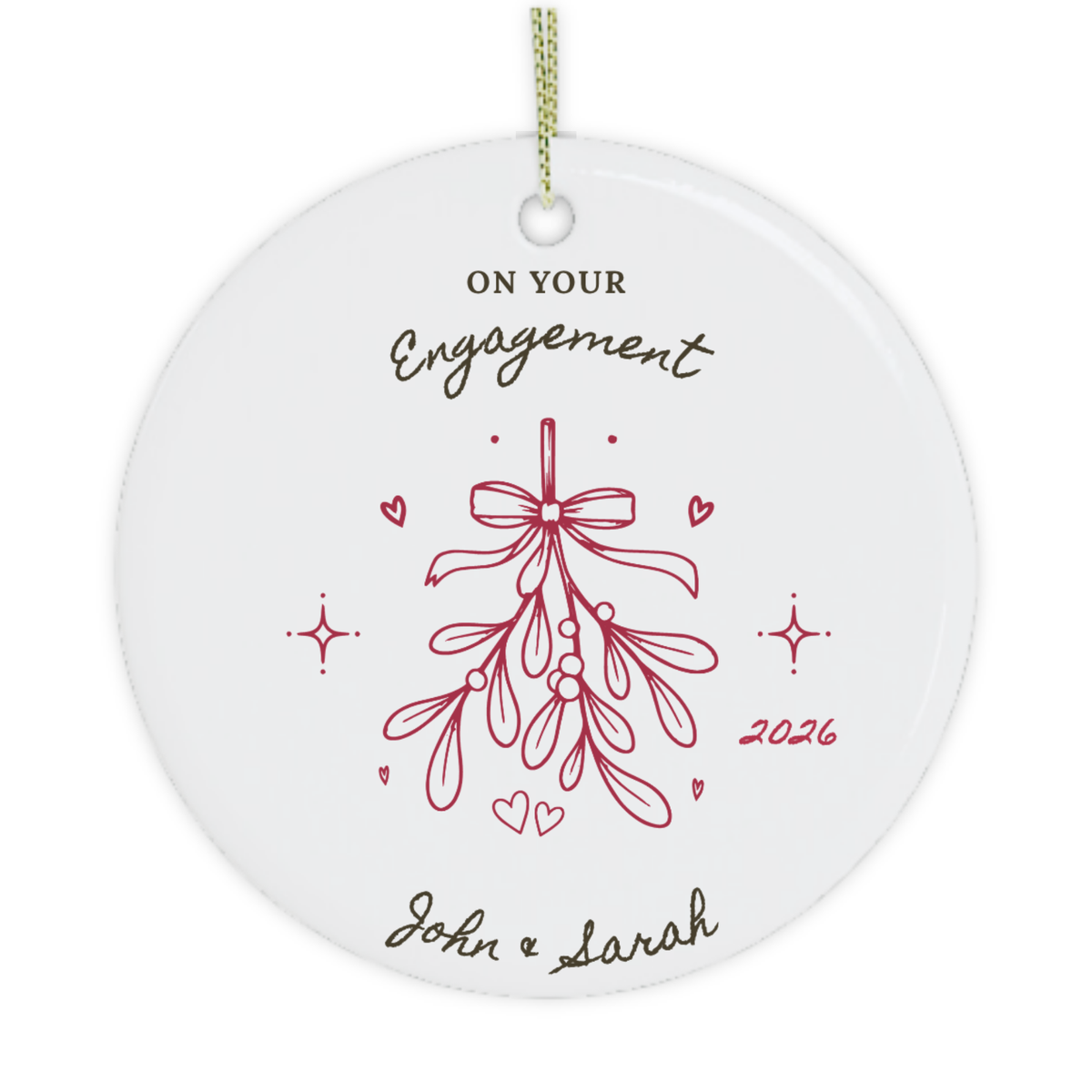 A round white ceramic personalised Christmas ornament with a hanging loop, featuring the text 'on your engagement 2026' in black and red lettering, with a mistletoe illustration.