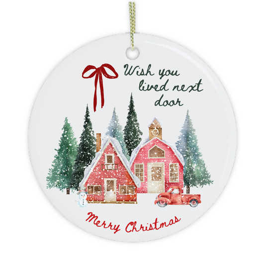 Close-up of Wish You Lived Next Door Christmas ornament with snowy houses and Merry Christmas