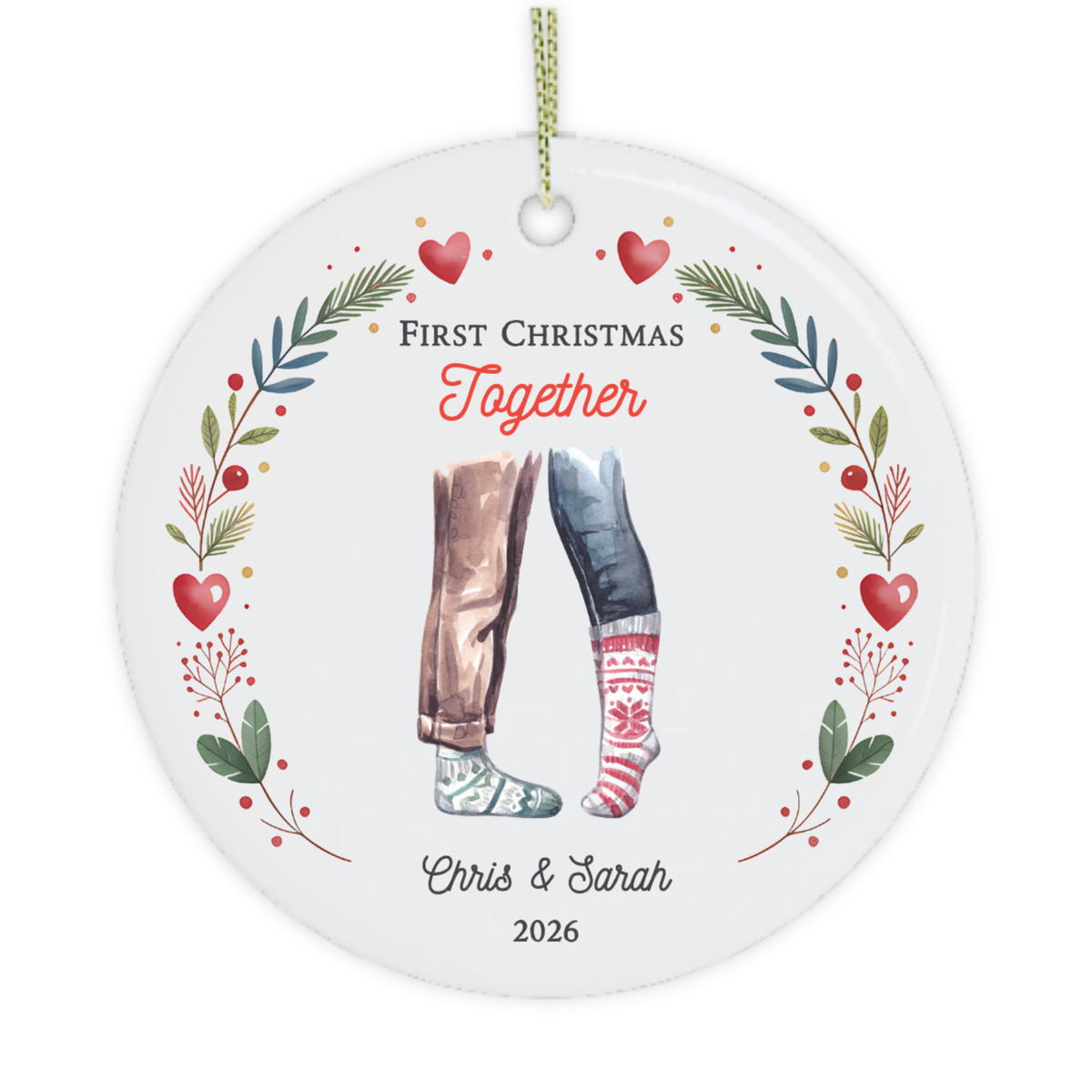 A personalised round Christmas ornament hanging on a decorated Christmas tree. The ornament features a white background with a colorful illustration of two legs in different outfits, surrounded by red hearts, green leaves, and the text 'First Christmas Together' and 'Chris & Sarah 2026'.