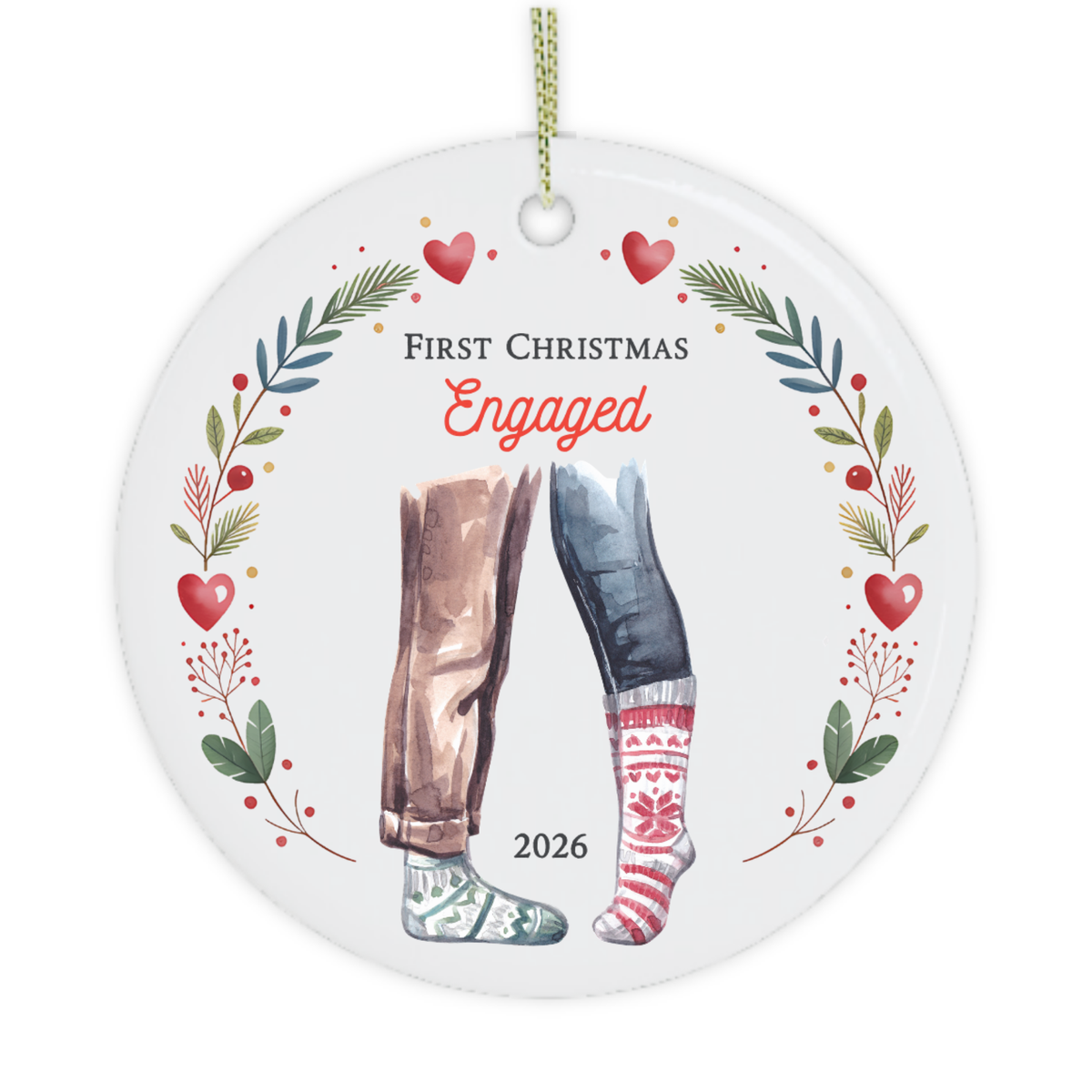 Round white ceramic Christmas ornament with a hanging loop, featuring a floral wreath border, red hearts, the words 'First Christmas Engaged,' and illustrated legs wearing jeans and knit socks with '2026' below.