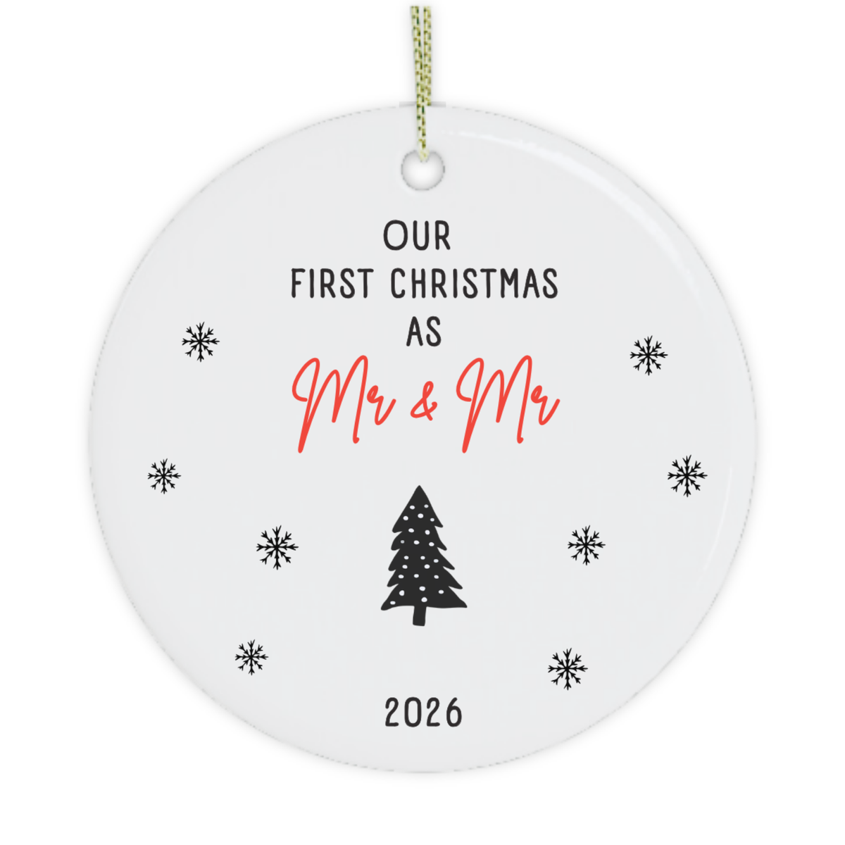 A round white ceramic Christmas ornament gift for gay couple with a hanging loop, featuring the printed text 'OUR FIRST CHRISTMAS AS Mr & Mr' in black and red, a black Christmas tree, and '2026' at the bottom, surrounded by small black snowflakes on a white background.