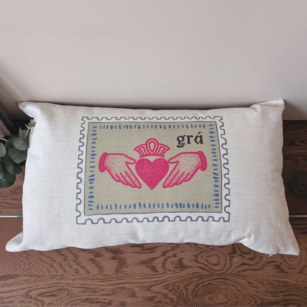 Close-up of Claddagh symbol and Grá Irish word on cushion