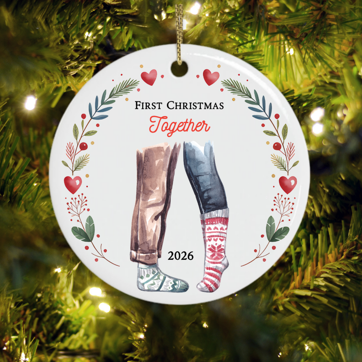 First Christmas Together 2026 Christmas ornament with watercolour legs, patterned festive socks and a botanical wreath