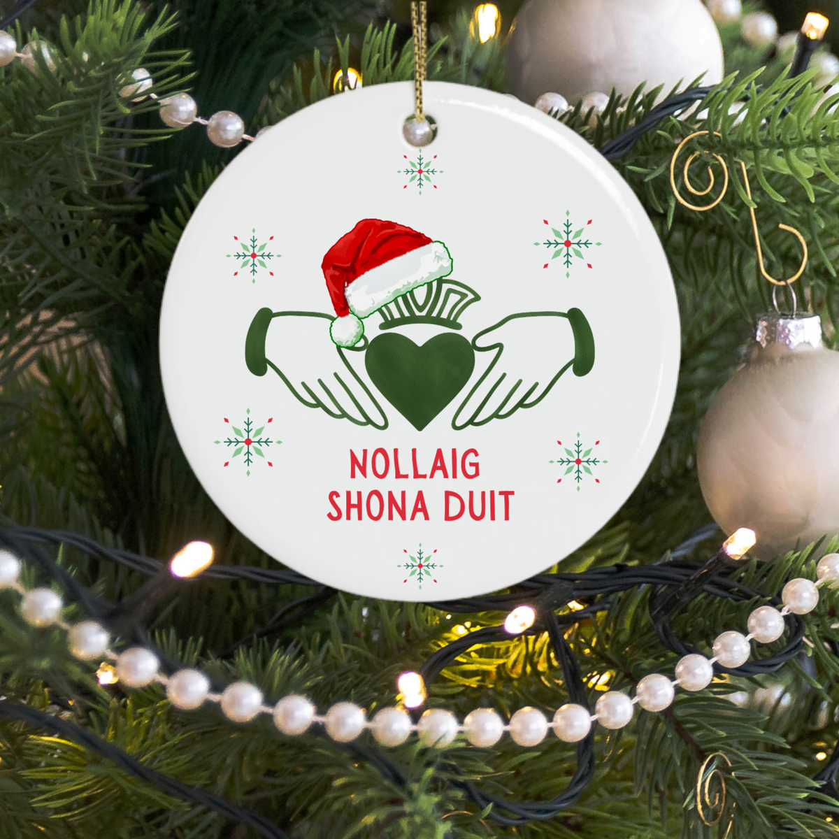 Nollaig Shona Duit Irish Christmas ornament hanging on a Christmas tree