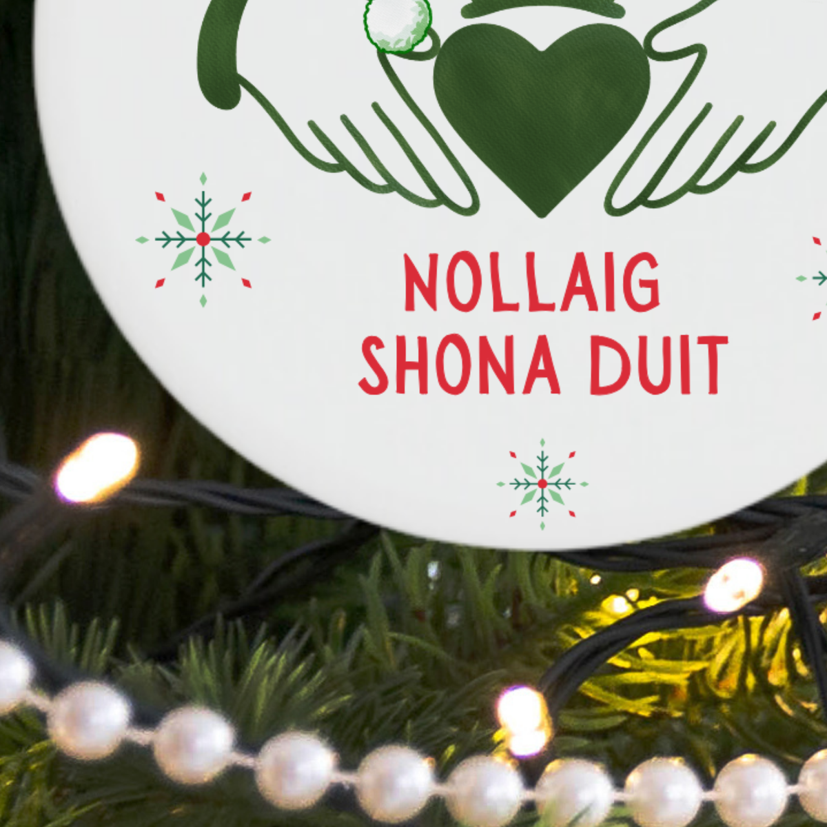 Close-up of the green Claddagh symbol and Santa hat on an Irish Christmas ornament