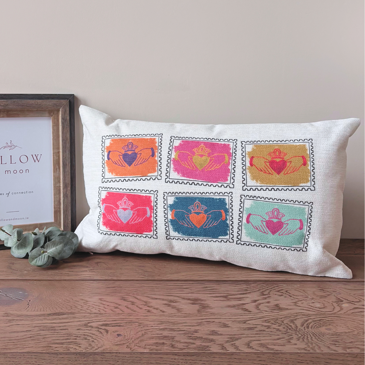 Colourful Irish Claddagh cushion with six stamp-style Claddagh designs
