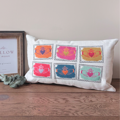 Colourful Irish Claddagh cushion with six stamp-style Claddagh designs