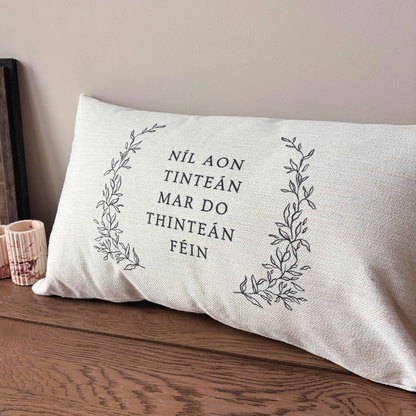 Irish phrase cushion featuring Níl aon tinteán mar do thinteán féin