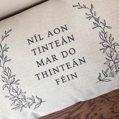 Close-up of Níl aon tinteán mar do thinteán féin Irish language cushion design