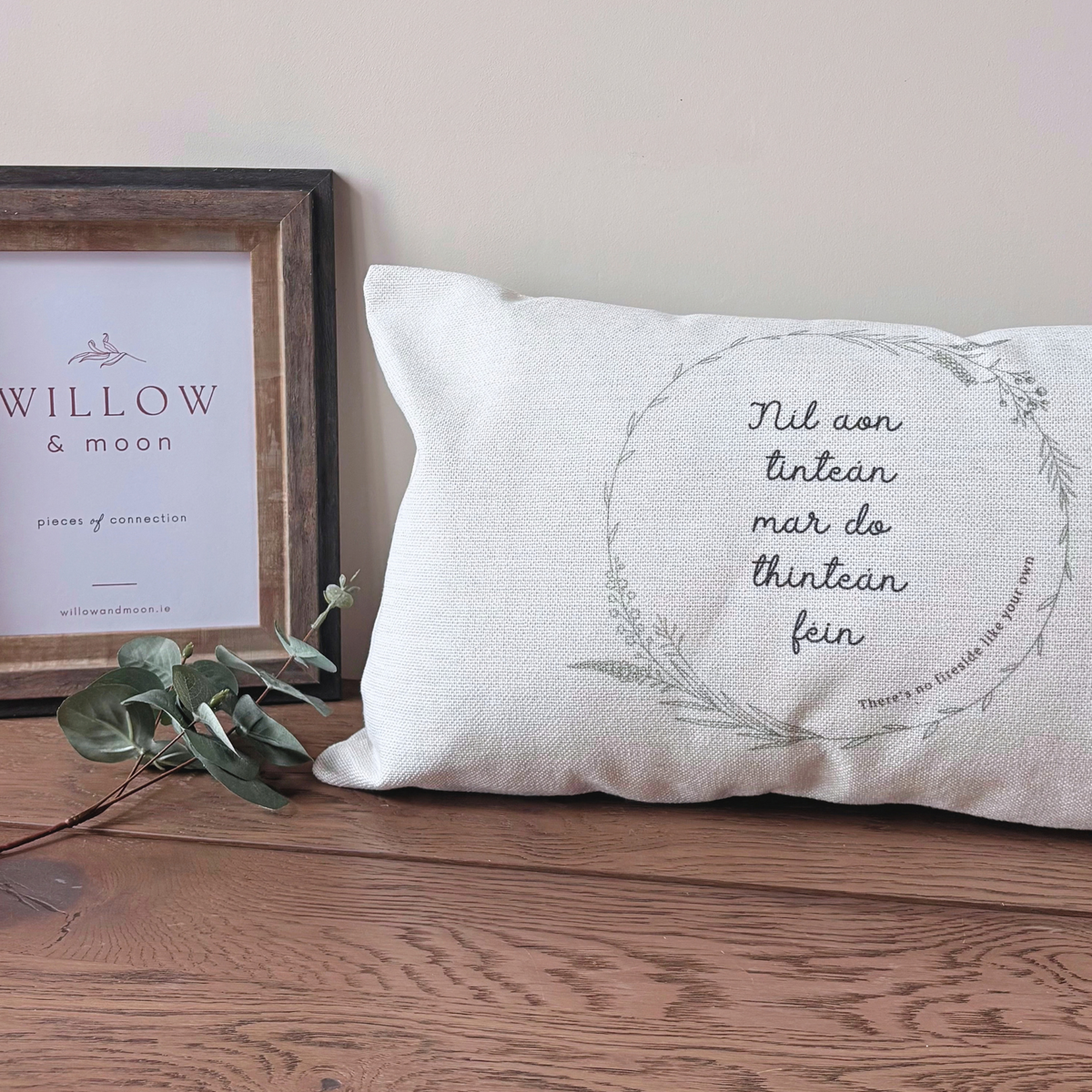 Níl Aon Tinteán Irish cushion with “There’s no place like home” saying and botanical wreath