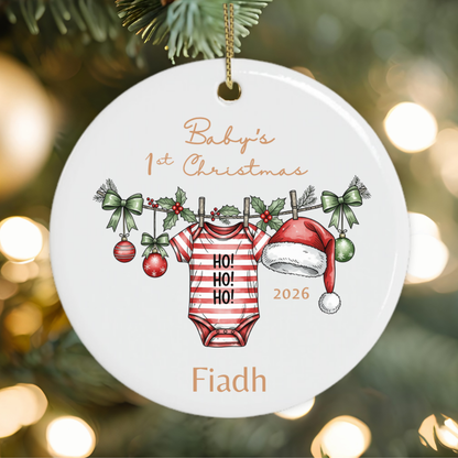 Personalised baby's first Christmas ornament featuring a festive baby grow, Santa hat, holly and baby's name.
