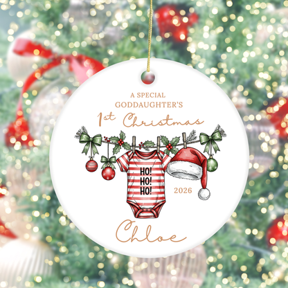 Personalised goddaughter's first Christmas ornament with baby grow, Santa hat, Christmas holly and name.