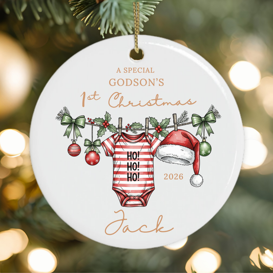 Personalised godson's first Christmas ornament featuring a festive baby grow, Santa hat, holly and his name.