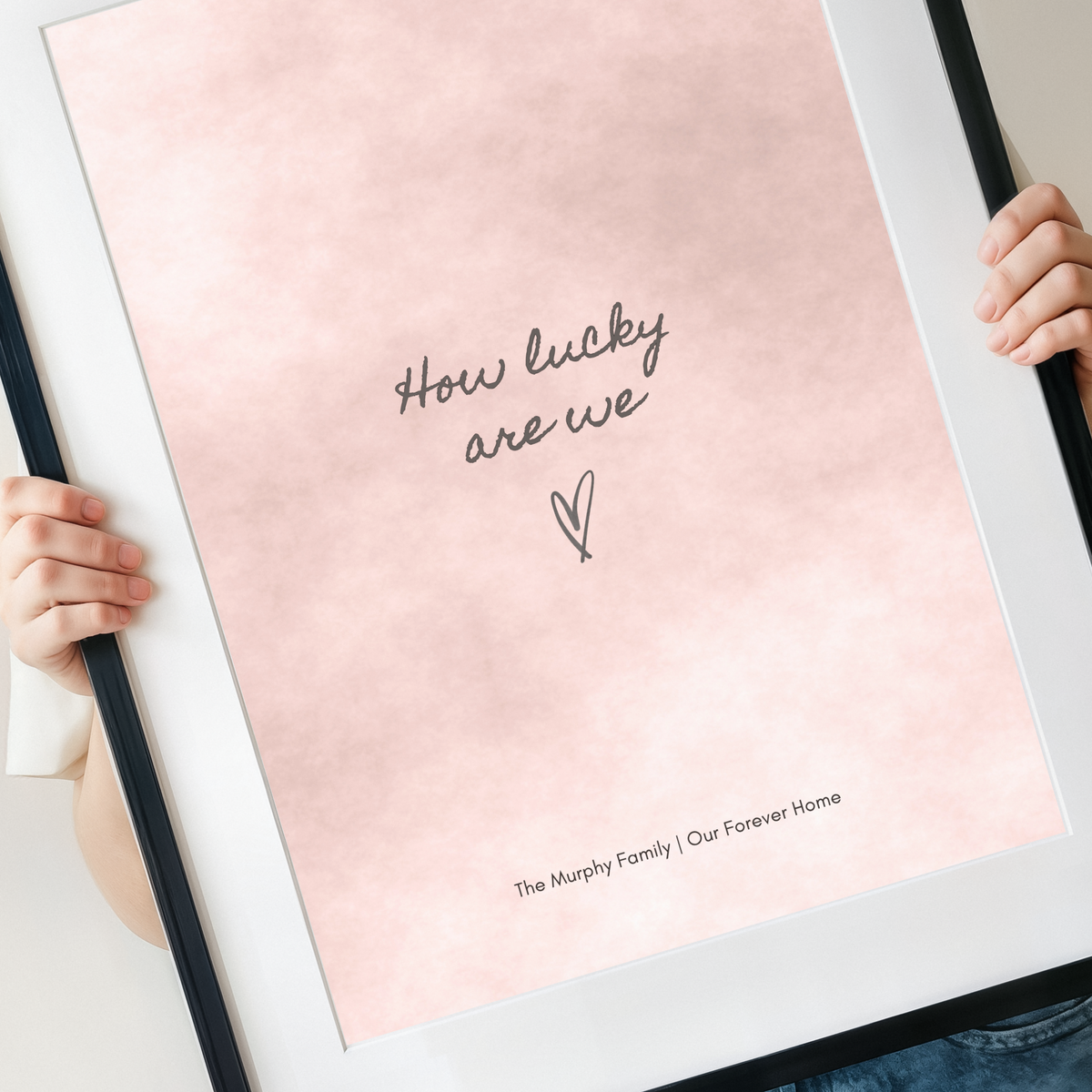 Close-up of personalised How Lucky Are We blush watercolour wall art
