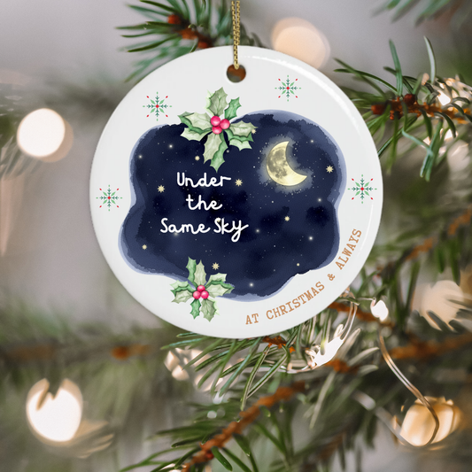 Under the Same Sky ceramic Christmas ornament hanging on a Christmas tree